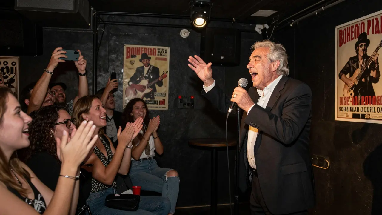 An elderly man singing passionately on stage as a cheering crowd films him.